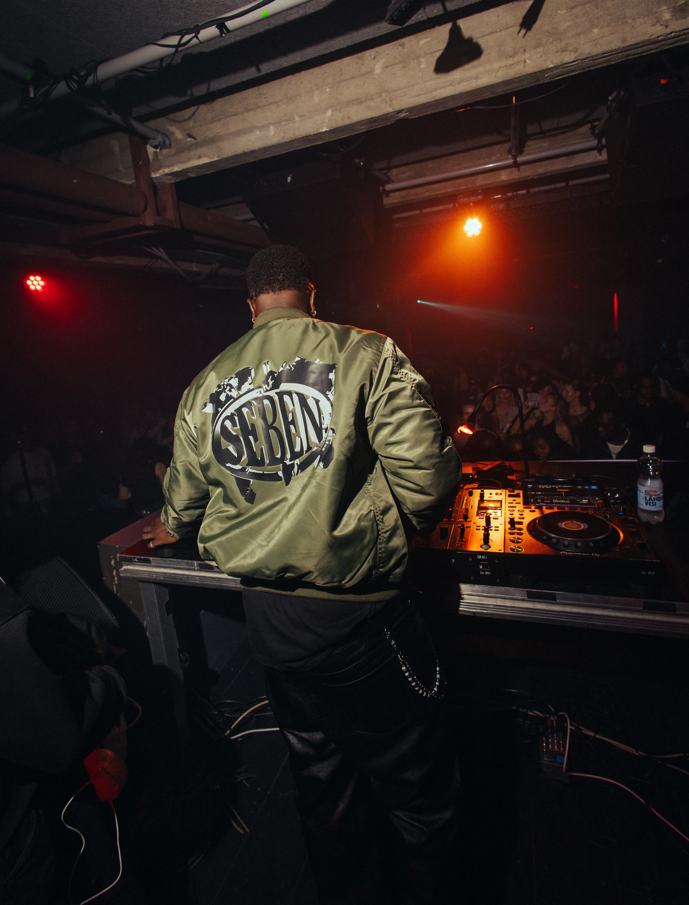 DJ SEBEN performing behind Pioneer CDJs